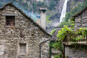 Europe, Switzerland, Ticino, Foroglio. View through the picturesque old village of Foroglio to the Calnègia waterfall. Europe, Switzerland, Ticino, Foroglio. View through the picturesque old village of Foroglio to the Calnègia waterfall.