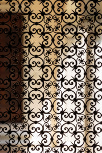 Europe, Italy, Piedmont, Orta San Giulio. An ornate, wrought-iron gate leads into the atrium of a house in the old town. Europe, Italy, Piedmont, Orta San Giulio. An ornate, wrought-iron gate leads into the atrium of a house in the old town.