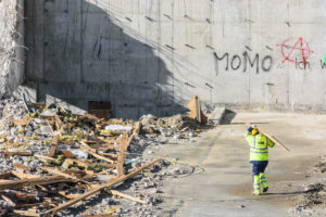 Vienna, Vienna: construction worker carries wooden board at demolition of building, rubble, graffiti in 22. Donaustadt, Vienna, Austria Vienna, Vienna: construction worker carries wooden board at demolition of building, rubble, graffiti in 22. Donaustadt, Vienna, Austria