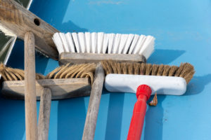 Brooms are lying on a blue floor Brooms are lying on a blue floor
