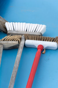 Brooms are lying on a blue floor Brooms are lying on a blue floor