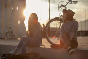 Two young women by bicycle in Barcelona, Catalonia, Spain Two young women by bicycle in Barcelona, Catalonia, Spain