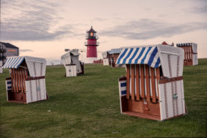 Beach chairs, lighthouse, North Sea Beach chairs, lighthouse, North Sea