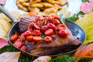 Braised pork belly with tomatoes, dish in the Romantik Hotel Turm, Fiè allo Sciliar, Alpe di Siusi, Eisacktal, South Tyrol, Italy Braised pork belly with tomatoes, dish in the Romantik Hotel Turm, Fiè allo Sciliar, Alpe di Siusi, Eisacktal, South Tyrol, Italy