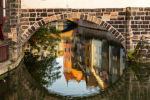 Reflection of house facades under the Henker's Bridge in the evening light, Nuremberg city center, Franconia, Bavaria, Germany Reflection of house facades under the Henker's Bridge in the evening light, Nuremberg city center, Franconia, Bavaria, Germany