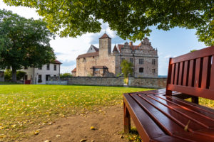 Bench under large linden tree in the courtyard of Cadolzburg Castle in the late afternoon, Cadolzburg, Franconia, Bavaria, Germany Bench under large linden tree in the courtyard of Cadolzburg Castle in the late afternoon, Cadolzburg, Franconia, Bavaria, Germany