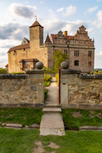 Entrance to the castle garden with a view of Cadolzburg Castle in the late afternoon, Cadolzburg, Franconia, Bavaria, Germany Entrance to the castle garden with a view of Cadolzburg Castle in the late afternoon, Cadolzburg, Franconia, Bavaria, Germany