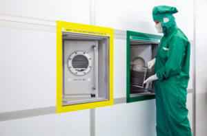Duisburg, North Rhine-Westphalia, Germany - high technology in the Ruhr area. A microtechnologist works in the clean room at the Fraunhofer Institute for Microelectronic Circuits and Systems. As an operator, she monitors the sputtering process. Duisburg, North Rhine-Westphalia, Germany - high technology in the Ruhr area. A microtechnologist works in the clean room at the Fraunhofer Institute for Microelectronic Circuits and Systems. As an operator, she monitors the sputtering process.