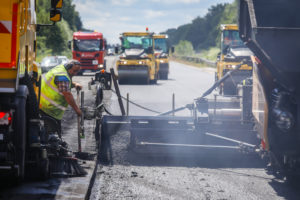 Road construction, asphalt pavers and road rollers paving whispered asphalt, rehabilitation of the A3 motorway between the crosses Kaiserberg and Breitscheid, Duisburg, North Rhine-Westphalia, Germany Road construction, asphalt pavers and road rollers paving whispered asphalt, rehabilitation of the A3 motorway between the crosses Kaiserberg and Breitscheid, Duisburg, North Rhine-Westphalia, Germany