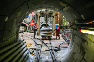 Oberhausen, Ruhr area, North Rhine-Westphalia, Germany, Emscher conversion, new construction of the Emscher AKE sewer, tunneling using the tubbing method at shaft 26, double pipe system, DN 2600, work processes in the shaft during tunneling, workers load the tunnel with tubbing stones, the ecological conversion of the Emscher system consists of the construction of a central sewage treatment system in the Ruhr area, the construction of sewers and the renaturation of the Emscher and its tributaries. Oberhausen, Ruhr area, North Rhine-Westphalia, Germany, Emscher conversion, new construction of the Emscher AKE sewer, tunneling using the tubbing method at shaft 26, double pipe system, DN 2600, work processes in the shaft during tunneling, workers load the tunnel with tubbing stones, the ecological conversion of the Emscher system consists of the construction of a central sewage treatment system in the Ruhr area, the construction of sewers and the renaturation of the Emscher and its tributaries.