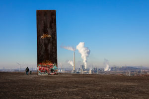 Essen, Ruhr area, North Rhine-Westphalia, Germany, the Schurenbach dump with the sculpture slab for the Ruhr area by Richard Serra, behind the RWE Carnap waste-to-energy plant and the Prosper coking plant in Bottrop. Essen, Ruhr area, North Rhine-Westphalia, Germany, the Schurenbach dump with the sculpture slab for the Ruhr area by Richard Serra, behind the RWE Carnap waste-to-energy plant and the Prosper coking plant in Bottrop.