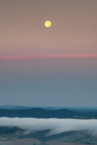 Moonset in the Saale valley in Thuringia during the sunrise. Moonset in the Saale valley in Thuringia during the sunrise.