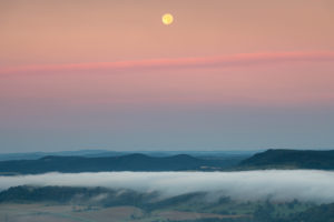 Moonset in the Saale valley in Thuringia during the sunrise. Moonset in the Saale valley in Thuringia during the sunrise.