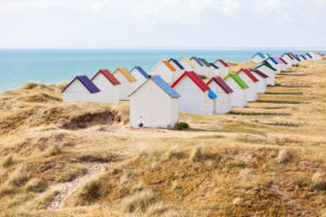 Eve mood at the colorful beach huts of Gouville on the Norman coast. Eve mood at the colorful beach huts of Gouville on the Norman coast.