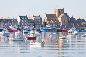 Boats in the harbor at Barfleur, with the Church of St. Nicolas behind. The town is one of the most beautiful places in France. Boats in the harbor at Barfleur, with the Church of St. Nicolas behind. The town is one of the most beautiful places in France.