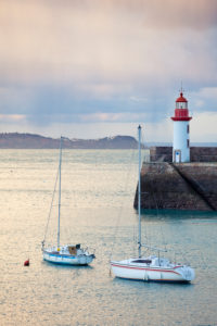 Morning mood at the lighthouse of Eruqy - harbor entrance with boats. Brittany France Morning mood at the lighthouse of Eruqy - harbor entrance with boats. Brittany France