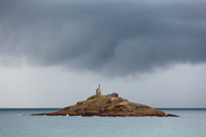 The tidal island of Ilot St. Michel at high tide during a summer thunderstorm The tidal island of Ilot St. Michel at high tide during a summer thunderstorm