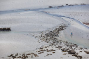 Anglers at low tide in Fresnaye Bay on Cap Frehel. Abstract view. Brittany France Anglers at low tide in Fresnaye Bay on Cap Frehel. Abstract view. Brittany France
