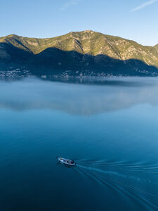Bay of Kotor in Montenegro on the Adriatic Sea, sunrise, boat on the water in the morning mist