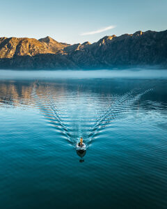Bay of Kotor in Montenegro on the Adriatic Sea, sunrise, boat on the water in the morning mist