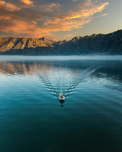 Bay of Kotor in Montenegro on the Adriatic Sea, sunrise, boat on the water in the morning mist