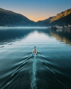 Bay of Kotor in Montenegro on the Adriatic Sea, sunrise, boat on the water in the morning mist
