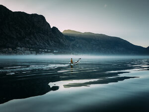Bay of Kotor in Montenegro on the Adriatic Sea, sunrise, boat on the water in the morning mist