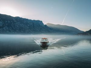 Bay of Kotor in Montenegro on the Adriatic Sea, sunrise, boat on the water in the morning mist