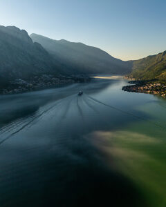 Bay of Kotor in Montenegro on the Adriatic Sea, boat on the water in the morning mist, Perast