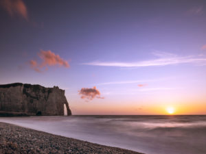 The Porte D'Aval rock gate near Étretat at sunset The Porte D'Aval rock gate near Étretat at sunset