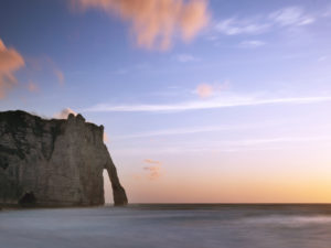 The Porte D'Aval rock gate near Étretat at sunset The Porte D'Aval rock gate near Étretat at sunset