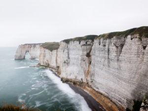 The Manneporte rock gate near Étretat in the fog. View from the cliff The Manneporte rock gate near Étretat in the fog. View from the cliff