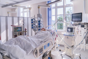 Patient in recovery after heart valve replacement surgery, operating room,