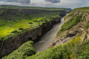 Gullfoss translated is Golden Falls. Gullfoss has two separate waterfalls, the upper one has a drop of 11 metres and the lower one 21 metres. The rock of the river bed was formed during an interglacial period. It is one of the most popular tourist attractions in Iceland.  