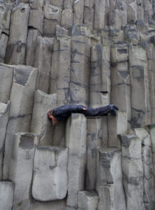 Teenagers on basalt columns at Reynisfjara, South Coast, Iceland