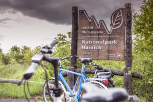 series - cycling tour, bicycles park in front of national park sign series - cycling tour, bicycles park in front of national park sign