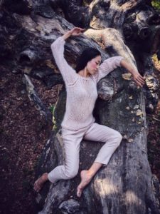 Young woman in nature between trees and tree trunks Young woman in nature between trees and tree trunks