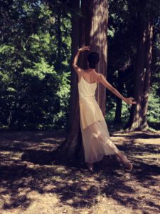 Young woman in nature between trees and tree trunks Young woman in nature between trees and tree trunks