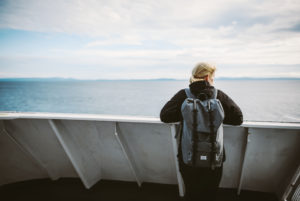 Woman on a ferry, looking into the distance, Vancouver Island, Canada