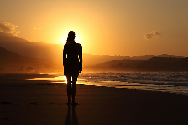 Woman Practicing Yoga Pose On The Beach At Sunrise In Kauai