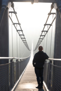 Germany, Saxony-Anhalt, Upper Harz, a man stands on the suspension bridge TitanRT, Rappbodetalsperre resin.