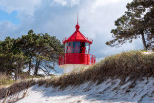 Germany, Mecklenburg-West Pomerania, Hiddensee, old lighthouse Gellen on a grass dune. Sunny summer day. Beautiful blue sky with clouds in the background, Baltic Sea. Germany, Mecklenburg-West Pomerania, Hiddensee, old lighthouse Gellen on a grass dune. Sunny summer day. Beautiful blue sky with clouds in the background, Baltic Sea.