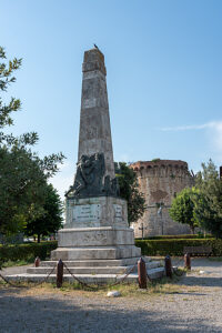 War memorial in front of a medieval fortress wall, San Gimignano, Tuscany, Italy