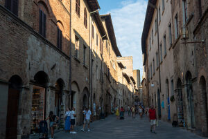 Lively old town alley in San Gimignano, Tuscany, Italy