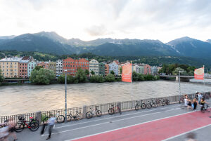 Colorful houses on the Inn River against an Alpine backdrop in Innsbruck, Austria