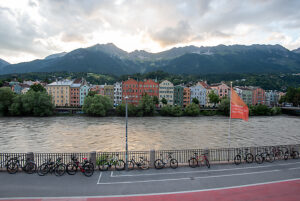 Colorful houses on the Inn River against an Alpine backdrop in Innsbruck, Austria