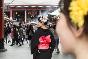 A young lady in a traditional robe in a temple in Tokyo