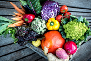 Organic box, wooden box with colourful vegetables and fruits, strong colours Organic box, wooden box with colourful vegetables and fruits, strong colours