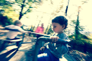 Playground, children on playground roundabout, blurred movement Playground, children on playground roundabout, blurred movement