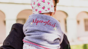 Baby, on father's arm, from behind Baby, on father's arm, from behind